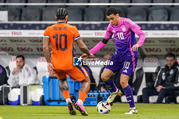 2024-03-26 - Memphis Depay of Netherlands battles for the ball with Jamal Musiala of Germany during the International Friendly football match between Germany and Netherlands on March 26, 2024 at Deutsche Bank Park in Frankfurt am Main, Germany - FOOTBALL - FRIENDLY GAME - GERMANY V NETHERLANDS - FRIENDLY MATCH - SOCCER