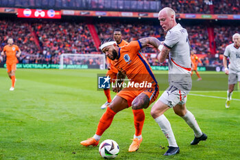 2024-06-10 - Memphis Depay of Netherlands battles for the ball with Valgeir Fridriksson of Iceland during the International Friendly football match between Netherlands and Iceland on June 10, 2024 at Stadion Feijenoord de Kuip in Rotterdam, Netherlands - FOOTBALL - FRIENDLY GAME - NETHERLANDS V ICELAND - FRIENDLY MATCH - SOCCER