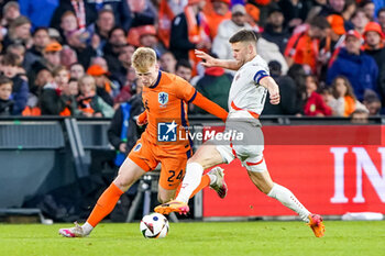 2024-06-10 - Jerdy Schouten of Netherlands battles for the ball with Johann Gudmundsson of Iceland during the International Friendly football match between Netherlands and Iceland on June 10, 2024 at Stadion Feijenoord de Kuip in Rotterdam, Netherlands - FOOTBALL - FRIENDLY GAME - NETHERLANDS V ICELAND - FRIENDLY MATCH - SOCCER