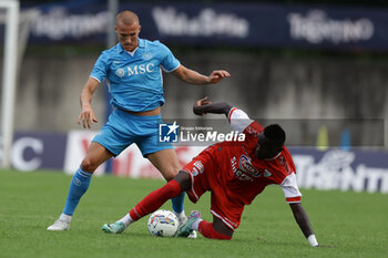 2024-07-20 - Napoli's Norwegian defender Leo Ostigard challenges for the ball with Mantova's Italian forward Davis Mensah during friendly match SSC Napoli vs Mantova in SSC Napoli's 2024-25 preseason training camp in val di sole in Trentino, Dimaro Folgarida

 - NAPOLI VS MANTOVA - FRIENDLY MATCH - SOCCER