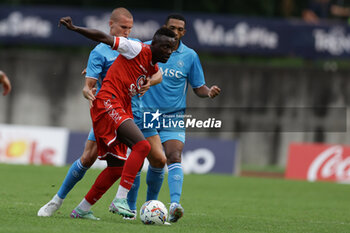 2024-07-20 - Napoli's Norwegian defender Leo Ostigard challenges for the ball with Mantova's Italian forward Davis Mensah during friendly match SSC Napoli vs Mantova in SSC Napoli's 2024-25 preseason training camp in val di sole in Trentino, Dimaro Folgarida

 - NAPOLI VS MANTOVA - FRIENDLY MATCH - SOCCER