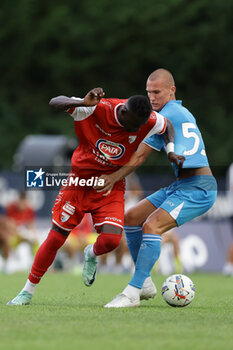 2024-07-20 - Napoli's Norwegian defender Leo Ostigard challenges for the ball with Mantova's Italian forward Davis Mensah during friendly match SSC Napoli vs Mantova in SSC Napoli's 2024-25 preseason training camp in val di sole in Trentino, Dimaro Folgarida

 - NAPOLI VS MANTOVA - FRIENDLY MATCH - SOCCER