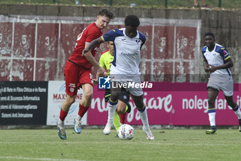 2024-07-24 - Alphadjo Cissè of Hellas Verona battle for the ball during Hellas Verona FC vs Virtus Verona FC, 3° Test Match, at Centro Sportivo 'La Pineta' on Folgaria (TN), on July 24, 2024. - HELLAS VERONA FC VS VIRTUS VERONA - FRIENDLY MATCH - SOCCER