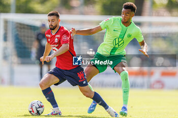 2024-07-24 - Edon Zhegrova (OSC Lille) and David Odogu (VfL Wolfsburg) during the Friendly football match between VfL Wolfsburg and LOSC Lille on 24 July 2024 at Jahnstadion in Rheda-Wiedenbrück, Germany - FOOTBALL - FRIENDLY GAME - WOLFSBURG V LILLE - FRIENDLY MATCH - SOCCER