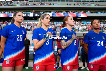 2024-10-24 - United States forward Emma Sears (26), midfielder Korbin Albert (3), midfielder Hal Hershfelt (19) and forward Yazmeen Ryan (24) look on during the playing of the US National Anthem - USA WOMEN VS ICELAND WOMEN - FRIENDLY MATCH - SOCCER