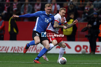2024-02-25 - Joonas Tamm of Estonia and Tymoteusz Puchacz of Poland during the UEFA Euro 2024, Play-off football match between Poland and Estonia on March 21, 2024 at PGE Narodowy stadium in Warsaw, Poland - FOOTBALL - EURO 2024 - PLAY OFF - POLAND V ESTONIA - UEFA EUROPEAN - SOCCER