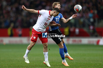 2024-02-25 - Bartosz Slisz of Poland and Mark Anders Lepik of Estonia during the UEFA Euro 2024, Play-off football match between Poland and Estonia on March 21, 2024 at PGE Narodowy stadium in Warsaw, Poland - FOOTBALL - EURO 2024 - PLAY OFF - POLAND V ESTONIA - UEFA EUROPEAN - SOCCER