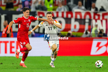 2024-06-29 - Christian Norgaard of Denmark tussles with Florian Wirtz of Germany during the UEFA Euro 2024, Round of 16 football match between Germany and Denmark on 29 June 2024 at Signal Iduna Park in Dortmund, Germany - FOOTBALL - EURO 2024 - 1/8 - GERMANY V DENMARK - UEFA EUROPEAN - SOCCER