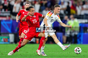 2024-06-29 - Yussuf Poulsen of Denmark tussles with Florian Wirtz of Germany during the UEFA Euro 2024, Round of 16 football match between Germany and Denmark on 29 June 2024 at Signal Iduna Park in Dortmund, Germany - FOOTBALL - EURO 2024 - 1/8 - GERMANY V DENMARK - UEFA EUROPEAN - SOCCER