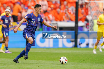 2024-07-02 - Tijani Reijnders of Netherlands shoots during the UEFA Euro 2024, Round of 16 football match between Romania and Netherlands on July 2, 2024 at Allianz Arena in Munich, Germany - FOOTBALL - EURO 2024 - 1/8 - ROMANIA V NETHERLANDS - UEFA EUROPEAN - SOCCER