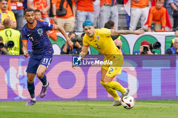 2024-07-02 - Cody Gakpo of Netherlands, Andrei Ratiu of Romania during the UEFA Euro 2024, Round of 16 football match between Romania and Netherlands on July 2, 2024 at Allianz Arena in Munich, Germany - FOOTBALL - EURO 2024 - 1/8 - ROMANIA V NETHERLANDS - UEFA EUROPEAN - SOCCER