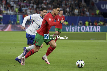 2024-07-05 - Cristiano Ronaldo of Portugal, left Theo Hernandez of France during the UEFA Euro 2024, quarter-final football match between Portugal and France on July 5, 2024 at Volksparkstadion in Hamburg, Germany - FOOTBALL - EURO 2024 - 1/4 - PORTUGAL V FRANCE - UEFA EUROPEAN - SOCCER