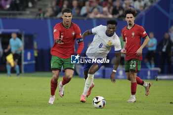 2024-07-05 - Cristiano Ronaldo of Portugal, Aurelien Tchouameni of France, Vitinha of Portugal during the UEFA Euro 2024, quarter-final football match between Portugal and France on July 5, 2024 at Volksparkstadion in Hamburg, Germany - FOOTBALL - EURO 2024 - 1/4 - PORTUGAL V FRANCE - UEFA EUROPEAN - SOCCER