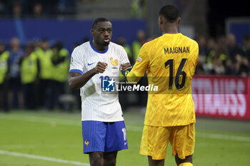 2024-07-05 - Youssouf Fofana of France celebrates scoring his penalty with Goalkeeper of France Mike Maignan during the penalty shootout of the UEFA Euro 2024, quarter-final football match between Portugal and France on July 5, 2024 at Volksparkstadion in Hamburg, Germany - FOOTBALL - EURO 2024 - 1/4 - PORTUGAL V FRANCE - UEFA EUROPEAN - SOCCER