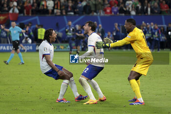 2024-07-05 - Jules Kounde, Theo Hernandez, goalkeeper of France Mike Maignan celebrate winning the penalty shootout of the UEFA Euro 2024, quarter-final football match between Portugal and France on July 5, 2024 at Volksparkstadion in Hamburg, Germany - FOOTBALL - EURO 2024 - 1/4 - PORTUGAL V FRANCE - UEFA EUROPEAN - SOCCER