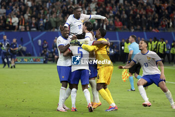 2024-07-05 - Marcus Thuram, Ousmane Dembele, Theo Hernandez, goalkeeper of France Mike Maignan, William Saliba of France celebrate winning the penalty shootout of the UEFA Euro 2024, quarter-final football match between Portugal and France on July 5, 2024 at Volksparkstadion in Hamburg, Germany - FOOTBALL - EURO 2024 - 1/4 - PORTUGAL V FRANCE - UEFA EUROPEAN - SOCCER