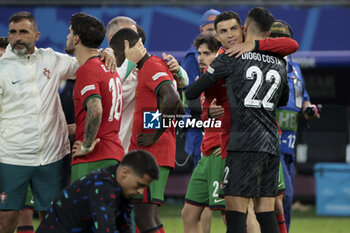 2024-07-05 - Cristiano Ronaldo of Portugal hugs Portugal goalkeeper Diogo Costa following the penalty shootout of the UEFA Euro 2024, quarter-final football match between Portugal and France on July 5, 2024 at Volksparkstadion in Hamburg, Germany - FOOTBALL - EURO 2024 - 1/4 - PORTUGAL V FRANCE - UEFA EUROPEAN - SOCCER