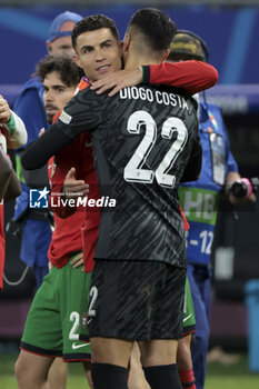 2024-07-05 - Cristiano Ronaldo of Portugal hugs Portugal goalkeeper Diogo Costa following the penalty shootout of the UEFA Euro 2024, quarter-final football match between Portugal and France on July 5, 2024 at Volksparkstadion in Hamburg, Germany - FOOTBALL - EURO 2024 - 1/4 - PORTUGAL V FRANCE - UEFA EUROPEAN - SOCCER