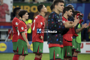 2024-07-05 - Cristiano Ronaldo of Portugal and teammates are dejected following the penalty shootout of the UEFA Euro 2024, quarter-final football match between Portugal and France on July 5, 2024 at Volksparkstadion in Hamburg, Germany - FOOTBALL - EURO 2024 - 1/4 - PORTUGAL V FRANCE - UEFA EUROPEAN - SOCCER