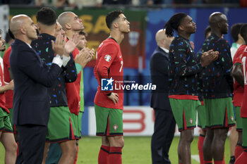 2024-07-05 - Cristiano Ronaldo of Portugal and teammates are dejected following the penalty shootout of the UEFA Euro 2024, quarter-final football match between Portugal and France on July 5, 2024 at Volksparkstadion in Hamburg, Germany - FOOTBALL - EURO 2024 - 1/4 - PORTUGAL V FRANCE - UEFA EUROPEAN - SOCCER