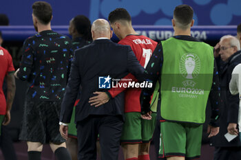 2024-07-05 - Coach of Portugal Roberto Martinez and Cristiano Ronaldo of Portugal leave the pitch following the penalty shootout of the UEFA Euro 2024, quarter-final football match between Portugal and France on July 5, 2024 at Volksparkstadion in Hamburg, Germany - FOOTBALL - EURO 2024 - 1/4 - PORTUGAL V FRANCE - UEFA EUROPEAN - SOCCER