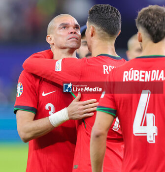 2024-07-05 - Pepe and Cristiano Ronaldo of Portugal look dejected after the UEFA Euro 2024, Quarter-finals football match between Portugal and France on July 5, 2024 at Volksparkstadion in Hamburg, Germany - FOOTBALL - EURO 2024 - 1/4 - PORTUGAL V FRANCE - UEFA EUROPEAN - SOCCER