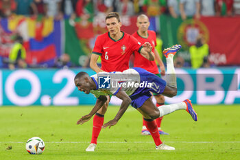 2024-07-05 - Randal Kolo Muani of France and Joao Palhinha of Portugal during the UEFA Euro 2024, Quarter-finals football match between Portugal and France on July 5, 2024 at Volksparkstadion in Hamburg, Germany - FOOTBALL - EURO 2024 - 1/4 - PORTUGAL V FRANCE - UEFA EUROPEAN - SOCCER