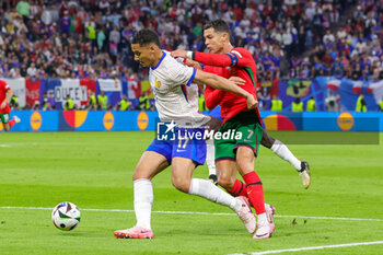 2024-07-05 - William Saliba of France and Cristiano Ronaldo of Portugal during the UEFA Euro 2024, Quarter-finals football match between Portugal and France on July 5, 2024 at Volksparkstadion in Hamburg, Germany - FOOTBALL - EURO 2024 - 1/4 - PORTUGAL V FRANCE - UEFA EUROPEAN - SOCCER