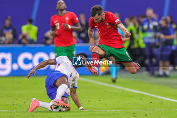 2024-07-05 - Aurelien Tchouameni of France and Bruno Fernandes of Portugal during the UEFA Euro 2024, Quarter-finals football match between Portugal and France on July 5, 2024 at Volksparkstadion in Hamburg, Germany - FOOTBALL - EURO 2024 - 1/4 - PORTUGAL V FRANCE - UEFA EUROPEAN - SOCCER