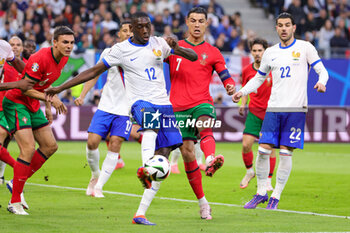 2024-07-05 - Randal Kolo Muani of France and Cristiano Ronaldo of Portugal during the UEFA Euro 2024, Quarter-finals football match between Portugal and France on July 5, 2024 at Volksparkstadion in Hamburg, Germany - FOOTBALL - EURO 2024 - 1/4 - PORTUGAL V FRANCE - UEFA EUROPEAN - SOCCER