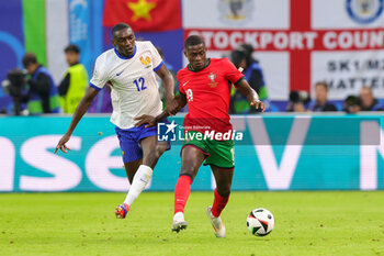 2024-07-05 - Randal Kolo Muani of France and Nuno Mendes of Portugal during the UEFA Euro 2024, Quarter-finals football match between Portugal and France on July 5, 2024 at Volksparkstadion in Hamburg, Germany - FOOTBALL - EURO 2024 - 1/4 - PORTUGAL V FRANCE - UEFA EUROPEAN - SOCCER