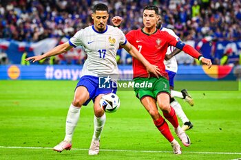 2024-07-05 - William SALIBA of France and Cristiano RONALDO of Portugal during the UEFA Euro 2024, Quarter-finals football match between Portugal and France on July 5, 2024 at Volksparkstadion in Hamburg, Germany - FOOTBALL - EURO 2024 - 1/4 - PORTUGAL V FRANCE - UEFA EUROPEAN - SOCCER