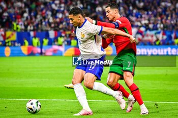 2024-07-05 - William SALIBA of France and Cristiano RONALDO of Portugal during the UEFA Euro 2024, Quarter-finals football match between Portugal and France on July 5, 2024 at Volksparkstadion in Hamburg, Germany - FOOTBALL - EURO 2024 - 1/4 - PORTUGAL V FRANCE - UEFA EUROPEAN - SOCCER