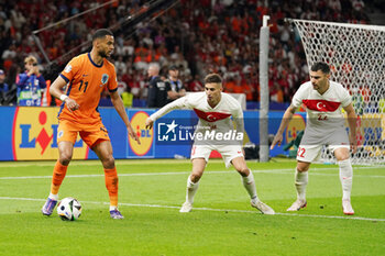 2024-07-06 - Cody Gakpo of Netherlands, Mert Muldur, Kaan Ayhan of Turkiye during the UEFA Euro 2024, Quarter-finals football match between Netherlands and Turkiye on July 6, 2024 at Olympiastadion in Berlin, Germany - FOOTBALL - EURO 2024 - 1/4 - NETHERLANDS V TURKIYE - UEFA EUROPEAN - SOCCER