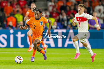 2024-07-06 - Jeremie Frimpong of Netherlands, Arda Guler of Turkiye during the UEFA Euro 2024, Quarter-finals football match between Netherlands and Turkiye on July 6, 2024 at Olympiastadion in Berlin, Germany - FOOTBALL - EURO 2024 - 1/4 - NETHERLANDS V TURKIYE - UEFA EUROPEAN - SOCCER