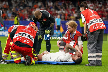 2024-07-06 - Samet Akaydin of Turkiye lies on the ground with an injury during the UEFA Euro 2024, Quarter-finals football match between Netherlands and Turkiye on July 6, 2024 at Olympiastadion in Berlin, Germany - FOOTBALL - EURO 2024 - 1/4 - NETHERLANDS V TURKIYE - UEFA EUROPEAN - SOCCER