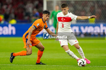 2024-07-06 - Tijani Reijnders of Netherlands, Arda Guler of Turkiye during the UEFA Euro 2024, Quarter-finals football match between Netherlands and Turkiye on July 6, 2024 at Olympiastadion in Berlin, Germany - FOOTBALL - EURO 2024 - 1/4 - NETHERLANDS V TURKIYE - UEFA EUROPEAN - SOCCER