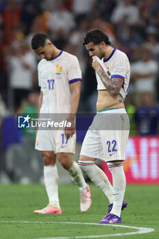 2024-07-09 - Munich , Germany 09.07.2024: French players Theo Hernandez of France, William Saliba of France disappointed after defeat in the UEFA EURO 2024 semi-finals, football match between Spain vs France at Munich Football Allianz Arena - UEFA EURO 2024 - SEMIFINALS - SPAIN VS FRANCE  - UEFA EUROPEAN - SOCCER