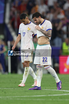 2024-07-09 - Munich , Germany 09.07.2024: French players Theo Hernandez of France, William Saliba of France disappointed after defeat in the UEFA EURO 2024 semi-finals, football match between Spain vs France at Munich Football Allianz Arena - UEFA EURO 2024 - SEMIFINALS - SPAIN VS FRANCE  - UEFA EUROPEAN - SOCCER