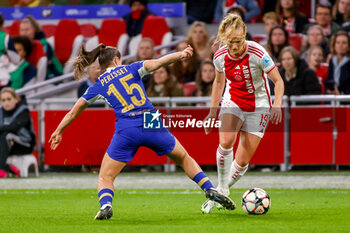 2024-03-19 - Tiny Hoekstra of AFC Ajax is challenged by Eve Perisset of Chelsea during the UEFA Women's Champions League, Quarter-finals, 1st leg football match between AFC Ajax and Chelsea FC on March 19, 2024 at Johan Cruijff ArenA in Amsterdam, Netherlands - FOOTBALL - WOMEN'S CHAMPIONS LEAGUE - AJAX V CHELSEA - UEFA CHAMPIONS LEAGUE WOMEN - SOCCER