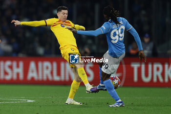 2024-02-21 - Barcellona's Polish forward Robert Lewandowski challenges for the ball with SSC Napoli's Cameroonian midfielder Andre Zambo Anguissa during the UEFA Champions League round 16 match between SSC Napoli vs Barcellona at the Diego Armando Maradona Stadium in Naples, southern Italy, on February 21, 2024. - SSC NAPOLI VS FC BARCELONA - UEFA CHAMPIONS LEAGUE - SOCCER