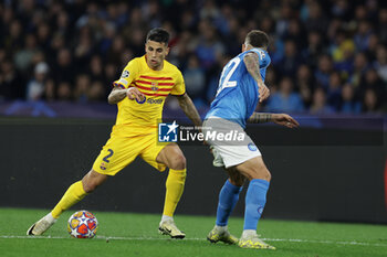 2024-02-21 - Barcellona's Portuguese defender Joao Cancelo challenges for the ball with SSC Napoli's Italian defender Giovanni Di Lorenzo during the UEFA Champions League round 16 match between SSC Napoli vs Barcellona at the Diego Armando Maradona Stadium in Naples, southern Italy, on February 21, 2024. - SSC NAPOLI VS FC BARCELONA - UEFA CHAMPIONS LEAGUE - SOCCER