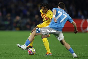 2024-02-21 - Barcellona's French defender Jules Kounde challenges for the ball with SSC Napoli’s forward Khvicha Kvaratskhelia during the UEFA Champions League round 16 match between SSC Napoli vs Barcellona at the Diego Armando Maradona Stadium in Naples, southern Italy, on February 21, 2024. - SSC NAPOLI VS FC BARCELONA - UEFA CHAMPIONS LEAGUE - SOCCER