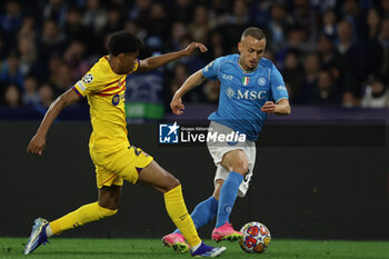2024-02-21 - Barcellona's Spanish forward Lamine Yamal challenges for the ball with SSC Napoli's Slovak midfielder Stanislav Lobotka during the UEFA Champions League round 16 match between SSC Napoli vs Barcellona at the Diego Armando Maradona Stadium in Naples, southern Italy, on February 21, 2024. - SSC NAPOLI VS FC BARCELONA - UEFA CHAMPIONS LEAGUE - SOCCER