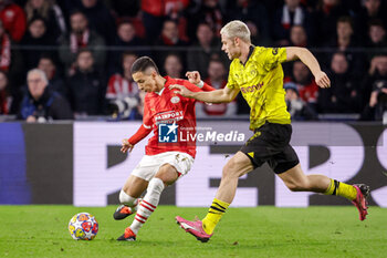 2024-02-20 - Mauro Junior of PSV battles for possession with Julian Ryerson of Borussia Dortmund during the UEFA Champions League, Round of 16 1st leg football match between PSV and Borussia Dortmund on February 20, 2024 at Philips Stadion in Eindhoven, Netherlands - FOOTBALL - CHAMPIONS LEAGUE - PSV V DORTMUND - UEFA CHAMPIONS LEAGUE - SOCCER
