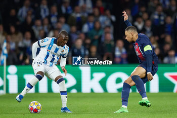 2024-03-05 - Hamari Traore of Real Sociedad competes for the ball with Kylian Mbappe of Paris Saint-Germain during the UEFA Champions League, Round of 16, 2nd leg football match between Real Sociedad and Paris Saint-Germain on March 5, 2024 at Reale Arena in San Sebastian, Spain - FOOTBALL - CHAMPIONS LEAGUE - REAL SOCIEDAD V PARIS SG - UEFA CHAMPIONS LEAGUE - SOCCER
