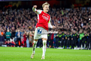 2024-03-13 - Martin Odegaard (8) of Arsenal celebrates scoring the first penalty during the UEFA Champions League, Round of 16, 2nd leg football match between Arsenal and FC Porto on 12 March 2024 at the Emirates Stadium in London, England - FOOTBALL - CHAMPIONS LEAGUE - ARSENAL V PORTO - UEFA CHAMPIONS LEAGUE - SOCCER