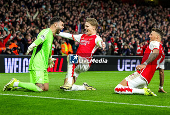 2024-03-13 - Arsenal win 4-2 on penalties and Martin Odegaard (8) and Ben White (4) celebrate with Goalkeeper David Raya (22) during the UEFA Champions League, Round of 16, 2nd leg football match between Arsenal and FC Porto on 12 March 2024 at the Emirates Stadium in London, England - FOOTBALL - CHAMPIONS LEAGUE - ARSENAL V PORTO - UEFA CHAMPIONS LEAGUE - SOCCER