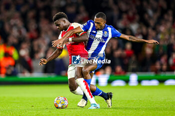 2024-03-13 - Bukayo Saka (7) of Arsenal and Otavio (31) of Porto during the UEFA Champions League, Round of 16, 2nd leg football match between Arsenal and FC Porto on 12 March 2024 at the Emirates Stadium in London, England - FOOTBALL - CHAMPIONS LEAGUE - ARSENAL V PORTO - UEFA CHAMPIONS LEAGUE - SOCCER