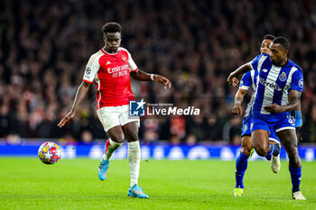 2024-03-13 - Bukayo Saka (7) of Arsenal and Otavio Ataide of FC Porto during the UEFA Champions League, Round of 16, 2nd leg football match between Arsenal and FC Porto on 12 March 2024 at the Emirates Stadium in London, England - FOOTBALL - CHAMPIONS LEAGUE - ARSENAL V PORTO - UEFA CHAMPIONS LEAGUE - SOCCER